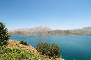 Fototapeta premium View from Akdamar Island, Lake Van, Van Gölü in the foreground and snow covered Mount Artos in the background, Van, Turkey