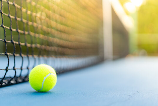 one tennis ball near net on blue hard court, tennis compettion concept