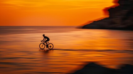 Fototapeta premium Cyclist speeds along coastal road at sunset with vivid orange sky, feeling energetic and free