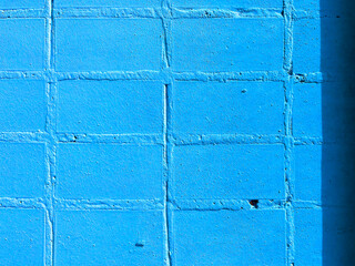 abstract blue background. the brick wall is painted with paint