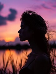 Silhouette of a woman near a lake, hair flowing in twilight, elegant and serene ambiance by purple-pink sky