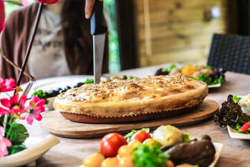 Person Cutting Pie on Wooden Table