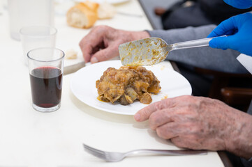 Close up of a Nurse serving food to senior people at nursing home. High quality photography