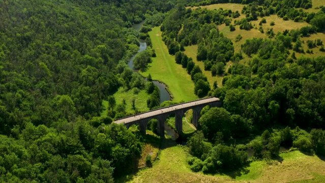 Headstone Viaduct aka Monsal Viaduct disused rail bridge now trail crossing Monsal Dale. Peak Distrtict National Park, England. Video pan up