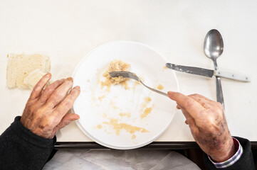 Close up of an elderly man having lunch at nursing home. High quality photo