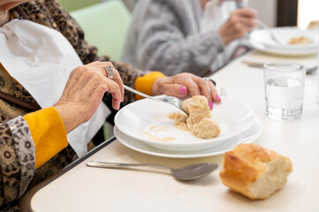 Close up of an elderly woman having lunch at retirement home. High quality photo