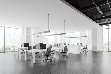 Modern workplace interior with pc monitors on desks in row, panoramic window - obrazy, fototapety, plakaty