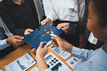 Corporate officer worker collaborate in office, connecting puzzle pieces with report paper on table...