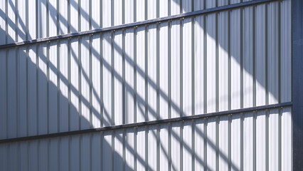 Corrugated steel wall background inside of warehouse building with light and shadow on surface ,...