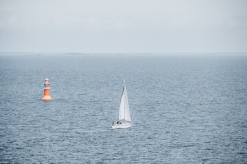 Obraz premium Lonley sailboat in the sea heading towards the unknown. Finnish archipelago