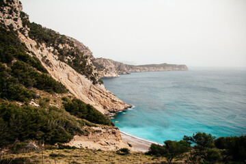 Deserted beach on with clear blue water at the coast of Mallorca.