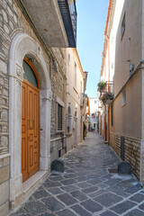 A street among the old houses of Troia, a medieval village in Puglia, Italy.