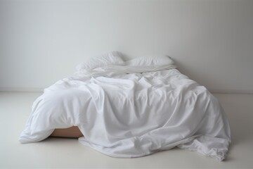 A simple bedding with a comforter photographed in a studio with nothing in the surroundings or in the background