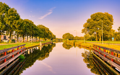 Reflection of the blue sky in the still waters of the Wilhelminakanaal canal in The Netherlands.