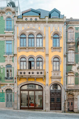 Fototapeta premium Typical colorful building facade of Porto city center. Traditional urban historic center architecture. Travel and monuments of Portugal. Next to the Douro river.