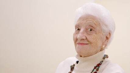Old woman smiling looking at the camera