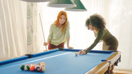 Women starting to play pool at home