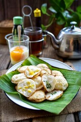 Kanom Krok, Thai Coconut Puddings, thai traditional breakfast set soft boiled egg and hot tea, retro style