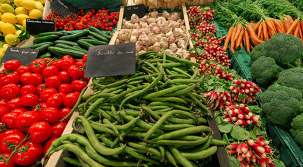 Organic vegetables stall at street market. Fresh vegetables from local farms. Vegetarian concept.