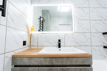 A bathroom featuring a sink, mirror, and towel rack