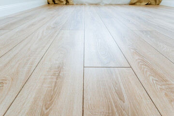 Close up view of hardwood plank flooring with a wooden table