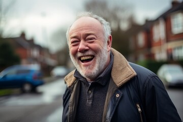 Portrait of a happy senior man on the street. He is laughing.