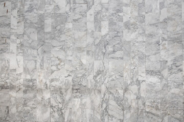 The large walls are decorated with white marble tiles with beautiful, detailed patterns.