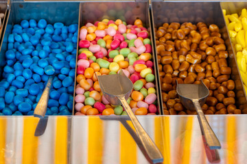 tray of candy with a spoon in each of the three trays