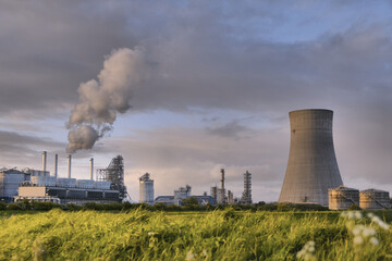 HDR Oil refinery, cooling towers, with smoke.