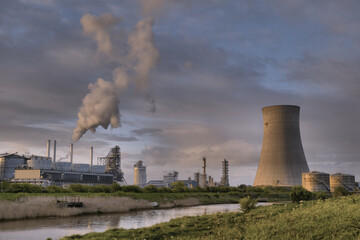 HDR Oil refinery, cooling towers, with smoke.