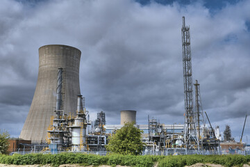 HDR Oil refinery, cooling towers, with smoke.