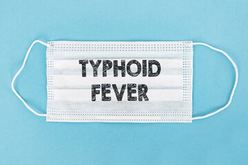 A protective face mask with the words Typhoid Fever printed on it, indicating a focus on medical...