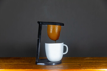 Preparing a barista coffee with an original cloth strainer. 