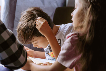 International Children Day. Beautiful Latino children playing with blocks on a white table....