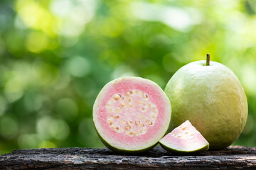 Pink guava fruits on natural background. - obrazy, fototapety, plakaty