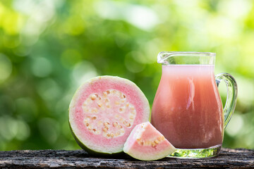Pink guava fruits and juice on natural background.