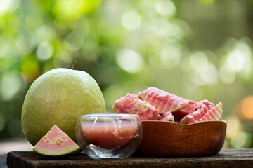 Pink guava fruits and juice on natural background. - obrazy, fototapety, plakaty