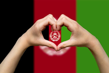 Afghanistan flag with two hands heart shape, hand heart love sign, patriotism and nationalism idea