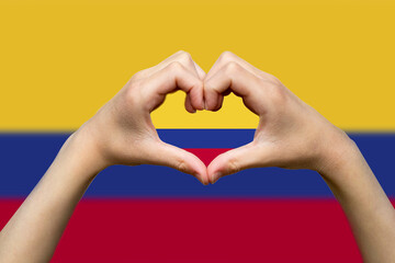 Colombia flag with two hands heart shape, hand heart love sign, patriotism and nationalism idea