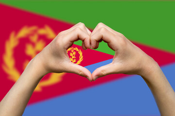 Eritrea flag with two hands heart shape, patriotism and nationalism idea, express love or affection 