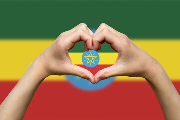 Ethiopia flag with two hands heart shape, vector design, patriotism and nationalism idea, express 