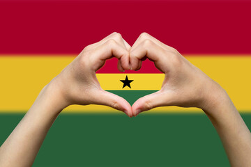 Ghana flag with two hands heart shape, patriotism and nationalism idea, express love or affection 