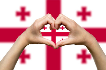 Georgia flag with two hands heart shape, patriotism and nationalism idea, express love or affection 