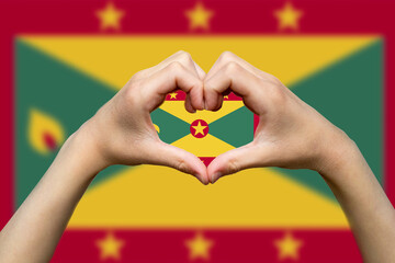 Grenada flag with two hands heart shape, patriotism and nationalism idea, express love or affection 