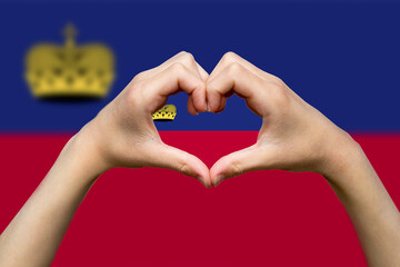 Liechtenstein flag with two hands heart shape, vector design, express love or affection concept