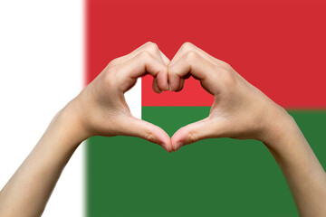 Madagascar flag with two hands heart shape, patriotism and nationalism idea, express love 