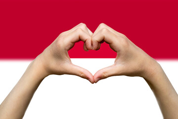 Monaco flag with two hands heart shape, vector design, express love or affection concept