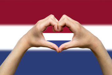 Netherlands flag with two hands heart shape, express love or affection concept, support or donate 