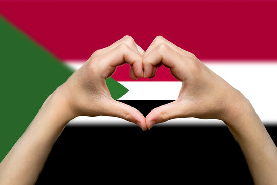 Sudan flag with two hands heart shape, patriotism and nationalism idea, express love or affection 