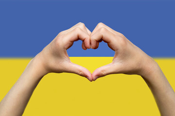 Ukraine flag with two hands heart shape, hand heart love sign, patriotism and nationalism idea